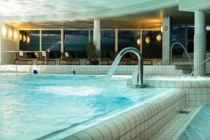 a swimming pool with a water fountain at signinahotel in Laax