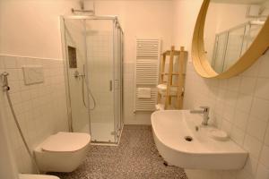 uma casa de banho com um WC, um lavatório e um chuveiro em La Briciola em Sirmione