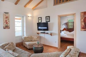 a living room with a couch and a tv and a bed at Casa Viter Zaostrog in Zaostrog