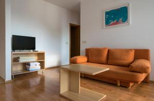 a living room with a couch and a table at House Vera in Baška Voda