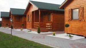 una fila de casas de madera en una calle en Sun holiday en Jezierzany