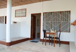 um quarto com uma mesa e cadeiras e uma porta em Divers Lodge Moalboal em Moalboal