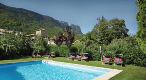 a swimming pool with lawn chairs and a group at Landgasthof Bad Turmbach in Appiano sulla Strada del Vino