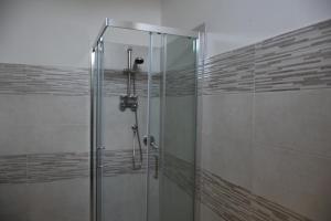 a shower with a glass door in a bathroom at Sa Mariposa in Muravera