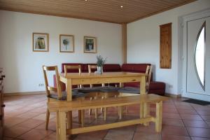 a dining room with a table and a couch at Haus am Mühlberg in Modautal