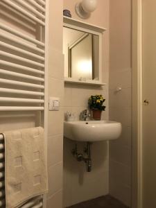 a bathroom with a sink and a mirror at La Sosta Fuori Stazione in Brescello +25 photos