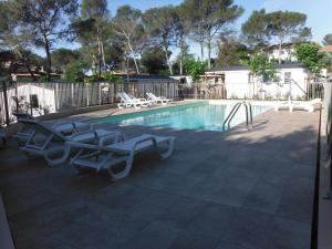 une piscine avec des chaises longues et une piscine dans l'établissement Camping l'Eléphant, à Saint-Raphaël