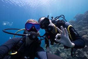 two people in scuba gear on the water at Divers Lodge Moalboal in Moalboal