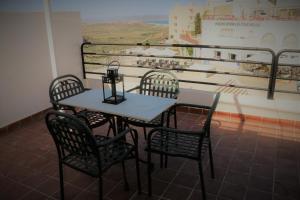 a table and chairs in a room with a mural at Hostal Arco Plaza in Mojácar