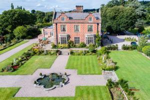 an aerial view of a large house with a garden at Willington Hall Hotel in Tarporley