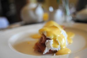 a white plate with a piece of food on it at Willington Hall Hotel in Tarporley