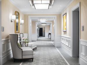 a corridor of a hotel room with a hallway at The Langham London in London