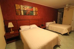 Postel nebo postele na pokoji v ubytování Hotel Chicama