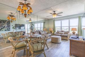 a living room with a table and chairs at Gulf View in South Padre Island