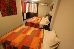 Postel nebo postele na pokoji v ubytování Hotel Chicama