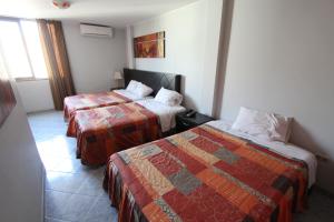 Postel nebo postele na pokoji v ubytování Hotel Chicama