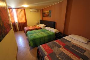 Postel nebo postele na pokoji v ubytování Hotel Chicama
