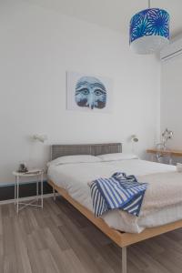 Posteľ alebo postele v izbe v ubytovaní Nonna Pina Art Rooms