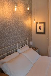 a bedroom with a bed and a wall at Assaporarte in Florence