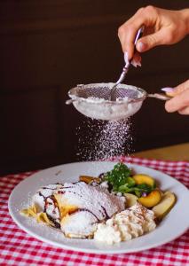 a plate of food on a table with a plate of food at Draggo House - Premium Rooms - Old Town in Krakow