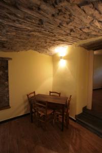 a dining room with a wooden table and chairs at Agriturismo Giumin in Rocchetta di Vara