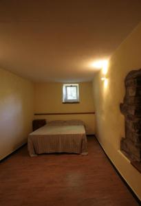 a bedroom with a bed in a room with a window at Agriturismo Giumin in Rocchetta di Vara