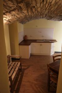 a kitchen with a counter and a table in a room at Agriturismo Giumin in Rocchetta di Vara