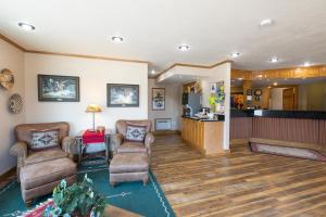 
a living room filled with furniture and a fire place at Crosswinds Inn in West Yellowstone
