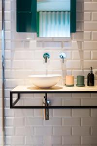 a bathroom counter with a sink and a mirror at Boutique B&B Graaf in Ghent