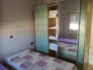 a bedroom with two beds and a mirror at Assos Villa in Káto Ássos