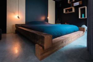 a bedroom with a large bed with blue sheets at Boutique B&B Graaf in Ghent