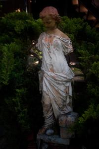 a statue of a woman standing in a garden at Villa Navigator in Nysa