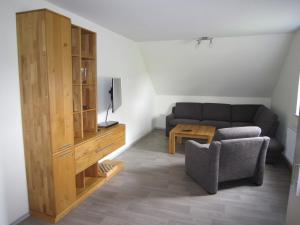 a living room with a couch and a table at Ferienwohnung Friesenstall in Heede