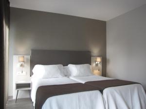 Posteľ alebo postele v izbe v ubytovaní Hotel Ton