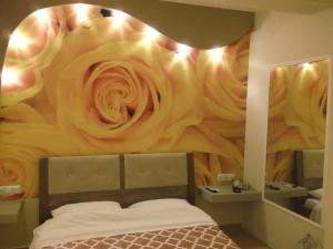 a bedroom with a flower mural on the wall at Dimitriadis fresh Edem in Limenas
