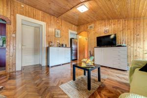 a living room with wood paneling and a television and a table at D&L Apartment in center in Pula