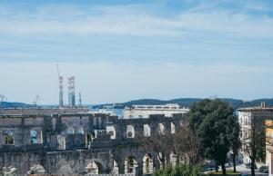 a view of an old building with a city in the background at D&L Apartment in center in Pula