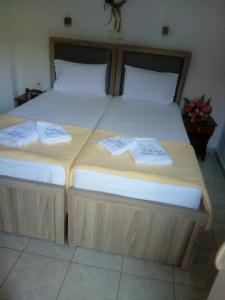 two beds in a room with towels on them at Chrisi Akti Hotel in Skala Potamias
