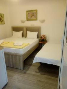 two beds in a small room withermottermottermott at Chrisi Akti Hotel in Skala Potamias