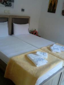 a bed with two towels on top of it at Chrisi Akti Hotel in Skala Potamias