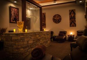 a lobby with a stone bar with candles and chairs at Little Creek Casino Resort in Kamilche