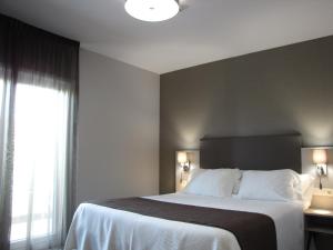 Posteľ alebo postele v izbe v ubytovaní Hotel Ton