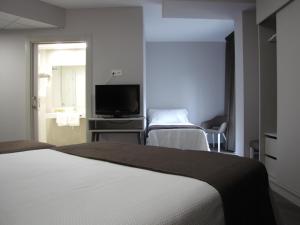 Кровать или кровати в номере Hotel Ton