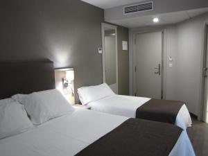 Posteľ alebo postele v izbe v ubytovaní Hotel Ton