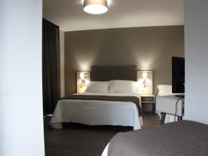 Posteľ alebo postele v izbe v ubytovaní Hotel Ton