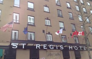 
a building with a flag on the front of it at The St. Regis Hotel in Vancouver
