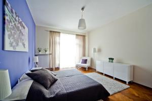 a bedroom with a bed and a blue wall at 4Seasons﻿ Apartments Cracow in Kraków