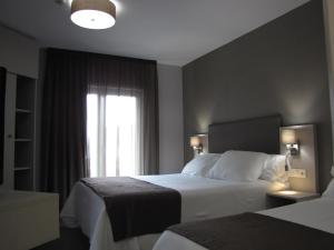 Posteľ alebo postele v izbe v ubytovaní Hotel Ton