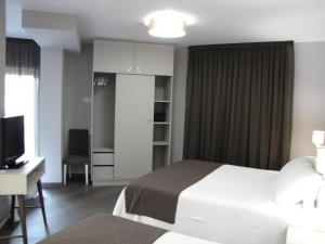 Posteľ alebo postele v izbe v ubytovaní Hotel Ton