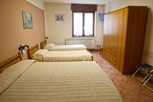 Voodi või voodid majutusasutuse Albergo Gusmeroli toas